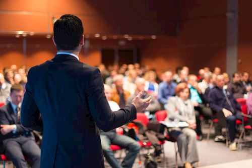 Speaker in front of a room full of people
